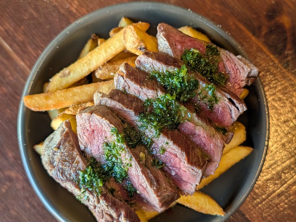 Carne Asada Fries: sliced rare steak on garlic fries with chimichurri