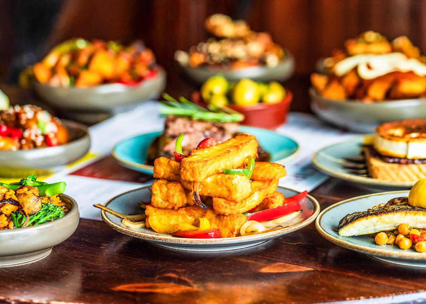 A table of tapas to share at Tapas Tapas: halloumi fries, steak, sea bass, olives and patatas
