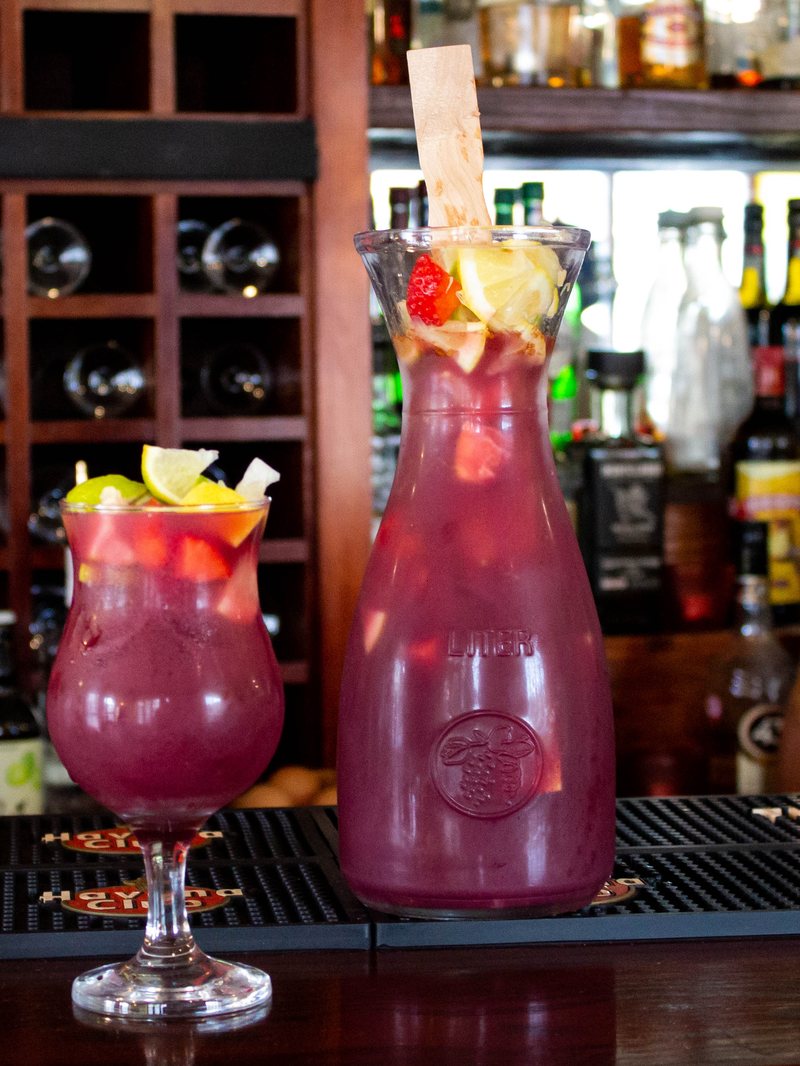 A jug and glass of traditional red sangría on the bar