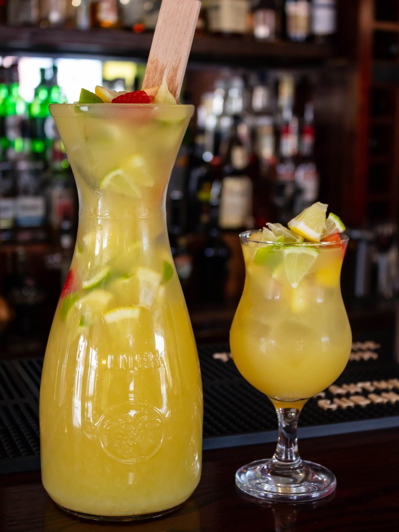A jug and glass of cava sangría on the bar